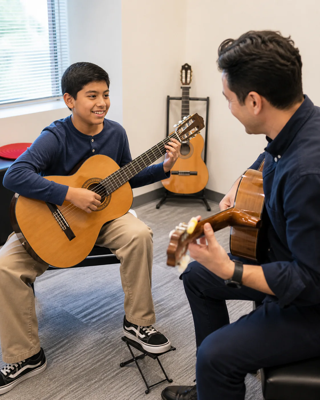 Child learning classical guitar with an encouraging teacher