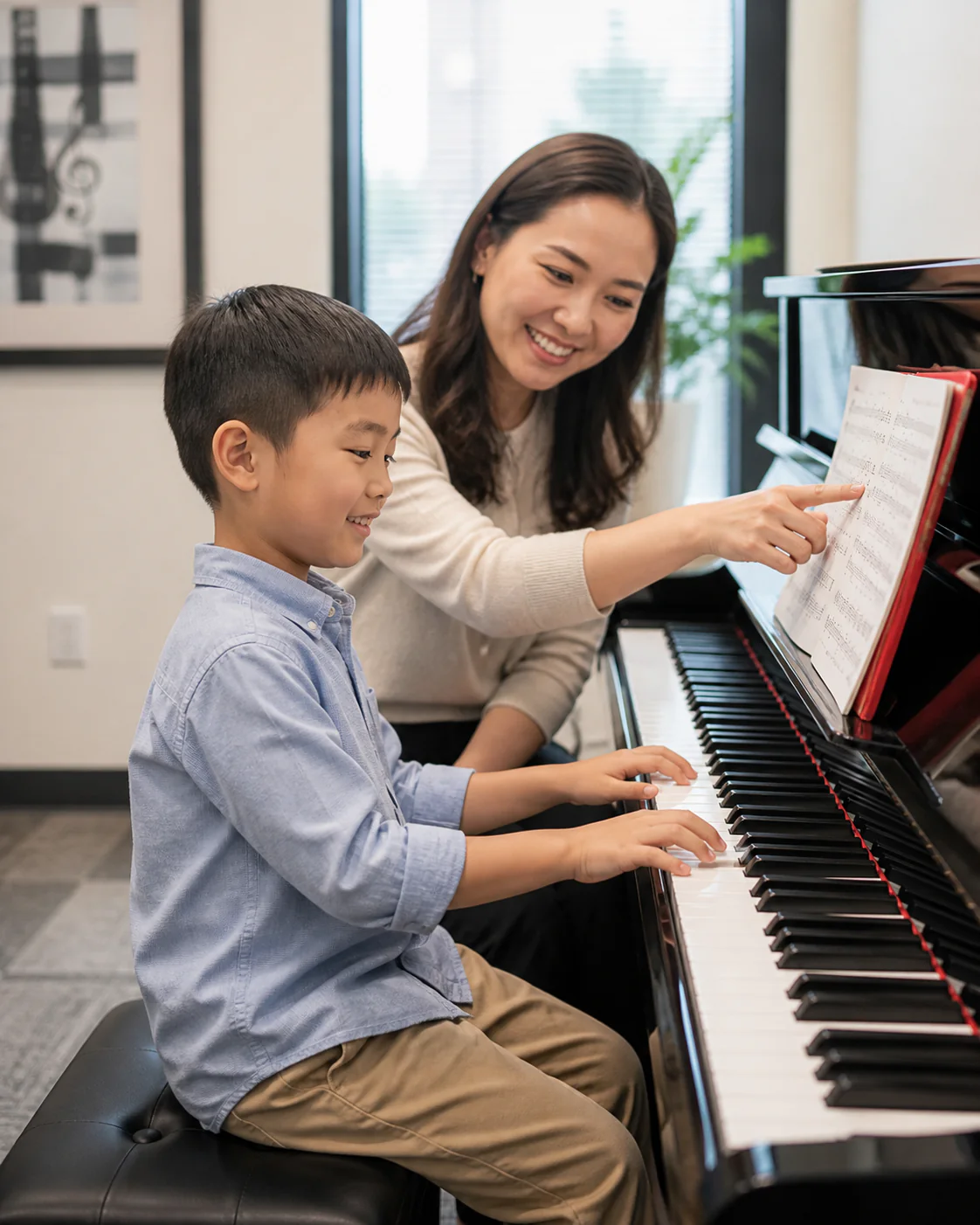 Child learning piano with an encouraging teacher